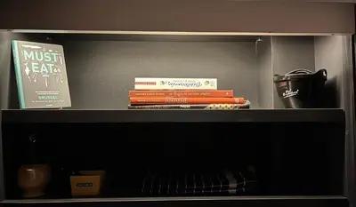 a book shelf with books on top of it at Entresol28 in Brussels