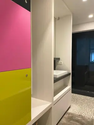 a bathroom with a colorful wall and a sink at Entresol28 in Brussels