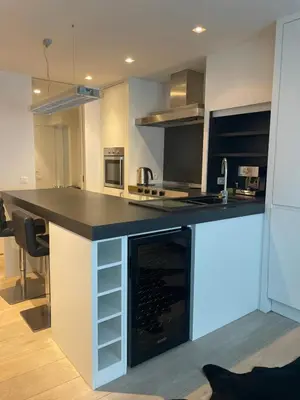 a kitchen with a island with a black counter top at Entresol28 in Brussels