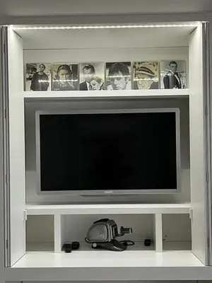 a flat screen tv in a white entertainment center at Entresol28 in Brussels