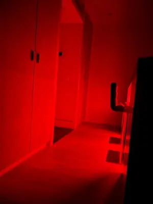 a red room with a chair and a red light at Entresol28 in Brussels