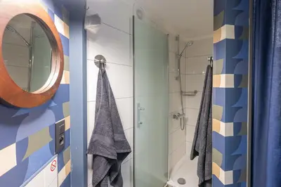 a bathroom with a shower and a mirror at Octagoon in Tessenderlo