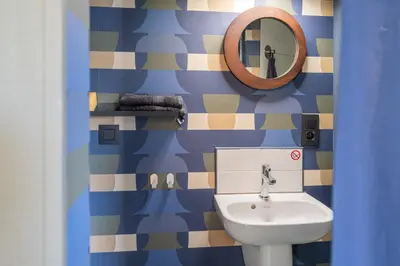a bathroom with a sink and a mirror at Octagoon in Tessenderlo