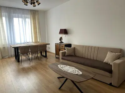 a living room with a couch and a table at MiMi in Brussels