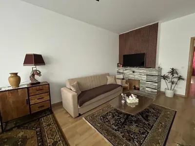 a living room with a couch and a table at MiMi in Brussels