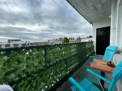 a balcony with two chairs and a table and a view at MiMi in Brussels