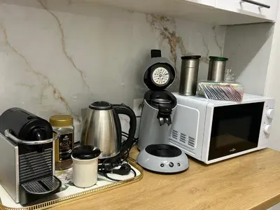a kitchen counter with a microwave and a coffee maker at MiMi in Brussels