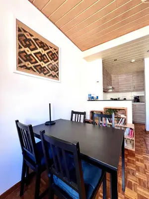 a dining room with a black table and chairs at Cosy haven in Aalst with terrace a green haven in Aalst