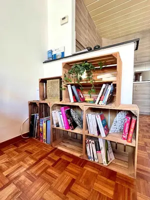 a book shelf filled with books in a room at Cosy haven in Aalst with terrace a green haven in Aalst
