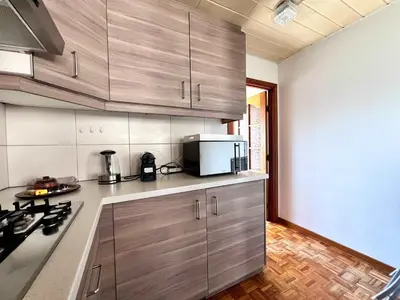 a kitchen with stainless steel cabinets and a microwave at Cosy haven in Aalst with terrace a green haven in Aalst