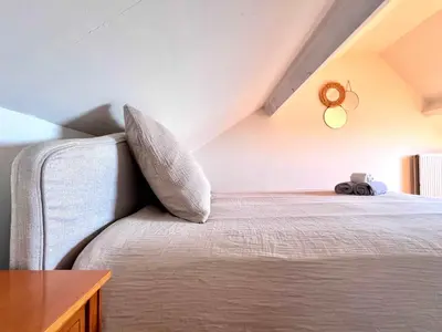 a bedroom with a bed with a pillow and a table at Cosy haven in Aalst with terrace a green haven in Aalst