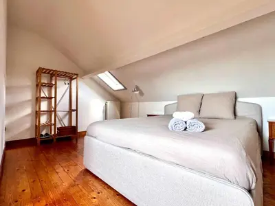 a bedroom with a bed with two pillows on it at Cosy haven in Aalst with terrace a green haven in Aalst