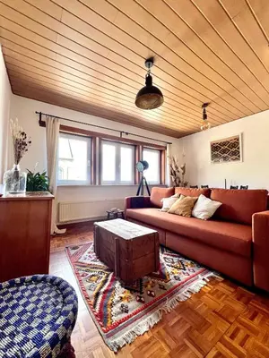 a living room with a couch and a table at Cosy haven in Aalst with terrace a green haven in Aalst