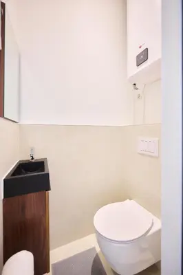 a bathroom with a white toilet and a sink at Apartment Duden 1 in Brussels