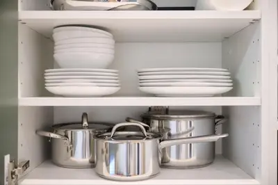 a cupboard with plates and pans and dishes at Apartment Duden 1 in Brussels