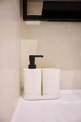 a bathroom sink with a faucet and two toilets at Apartment Duden 1 in Brussels