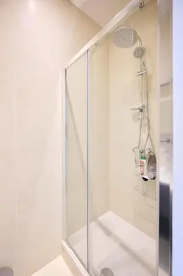 a shower with a glass door in a bathroom at Apartment Duden 1 in Brussels