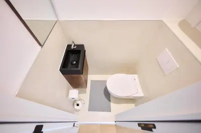 a small bathroom with a toilet and a sink at Apartment Duden 1 in Brussels