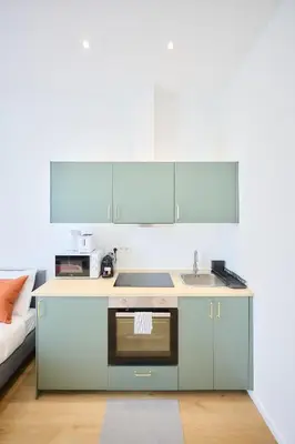 a kitchen with a sink and a microwave at Apartment Duden 1 in Brussels