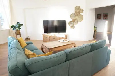 a living room with a blue couch and a table at Charming, spacious & luxurious - 2-bedroom apartment at wonderful location in Antwerp