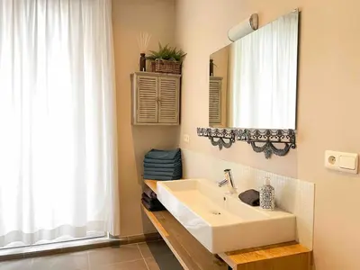 a bathroom with a white sink and a mirror at Charming, spacious & luxurious - 2-bedroom apartment at wonderful location in Antwerp