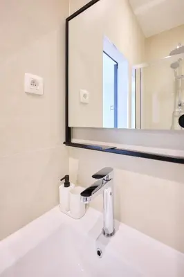 a bathroom with a sink and a mirror at Apartment Wiels 3 in Brussels