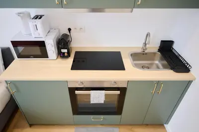 a small kitchen with a sink and a counter at Apartment Wiels 3 in Brussels