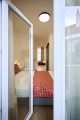 a bedroom with a bed and a mirror at Apartment Wiels 3 in Brussels
