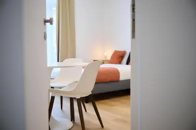 a bedroom with a bed and a table and chairs at Apartment Combaz 4 in Mellet