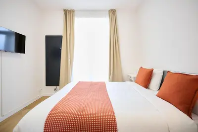 a bedroom with a bed and a large window at Apartment Combaz 4 in Mellet
