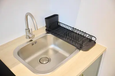 a kitchen sink with a keyboard on top of it at Apartment Combaz 4 in Mellet
