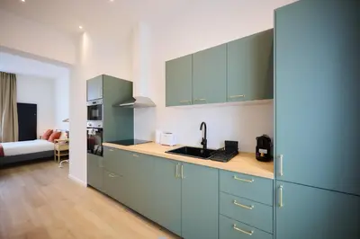 a kitchen with blue cabinets and a sink at Apartment Berthelot 5 in Brussels