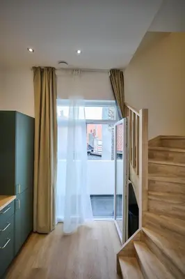 a room with a sliding glass door with a window at Apartment La Barrière 6 in Brussels