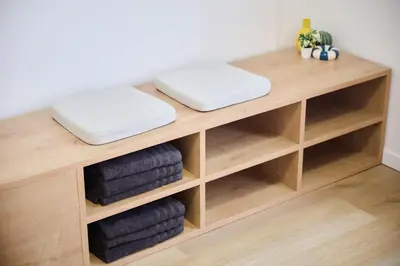 a wooden shelf with three towels on top at Apartment La Barrière 6 in Brussels