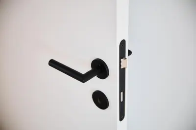 a black door handle on a white door at Apartment La Barrière 6 in Brussels