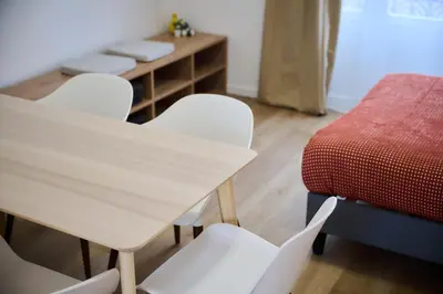 a table and chairs in a room with a bed at Apartment La Barrière 6 in Brussels