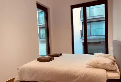 a bedroom with a bed with two pillows on it at The Diplomatic Apartment in Brussels