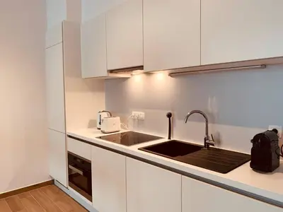 a kitchen with white cabinets and a sink at The Diplomatic Apartment in Brussels