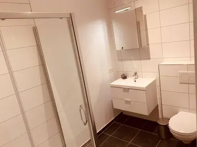 a bathroom with a shower and a toilet and a sink at The Diplomatic Apartment in Brussels