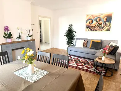 a living room with a table and a couch at Atomium Brussels Canopy in Brussels