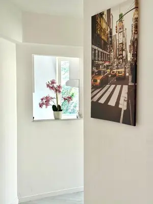 a wall with two pictures and a flower pot on it at Atomium Brussels Canopy in Brussels
