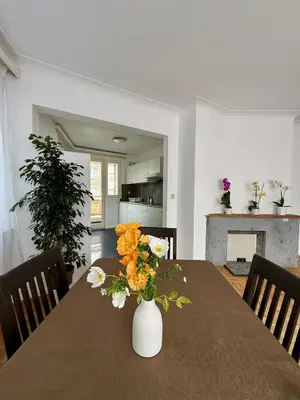 a dining room table with a vase with flowers on it at Atomium Brussels Canopy in Brussels