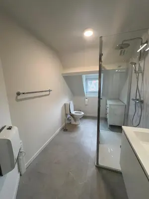 a bathroom with a shower and a sink and a toilet at Denderhuis in Dendermonde