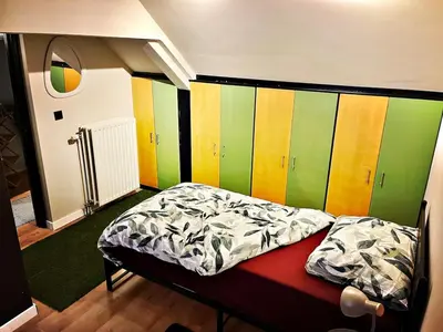 a bed in a room with a colorful wall at De Zweverik in Dessel