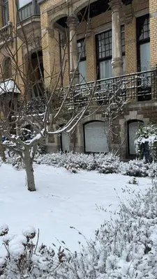 a snow covered building with a staircase in front of it at Boutique Cogels Osy in Antwerp