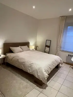 a bedroom with a large bed and a window at A joyful place in Ghent