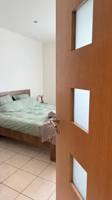 a door leading to a bedroom with a bed at A joyful place in Ghent