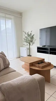 a living room with a coffee table and a tv at A joyful place in Ghent