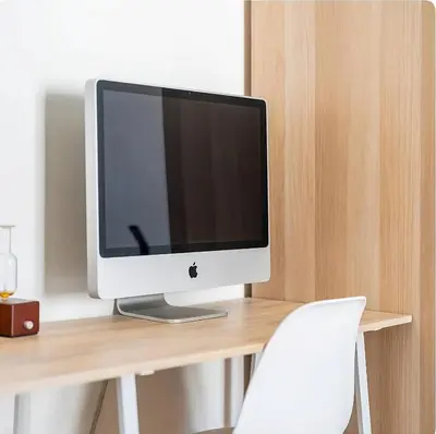 a computer monitor sitting on top of a wooden desk at Brussels Royal - Freedom Square in Brussels