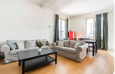 a living room with a couch and a table at Brussels Royal - Freedom Square in Brussels